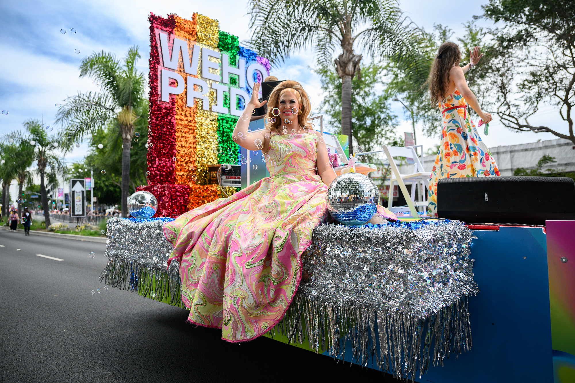 A drag performer rides on a sparkly float during the WeHo Pride parade.