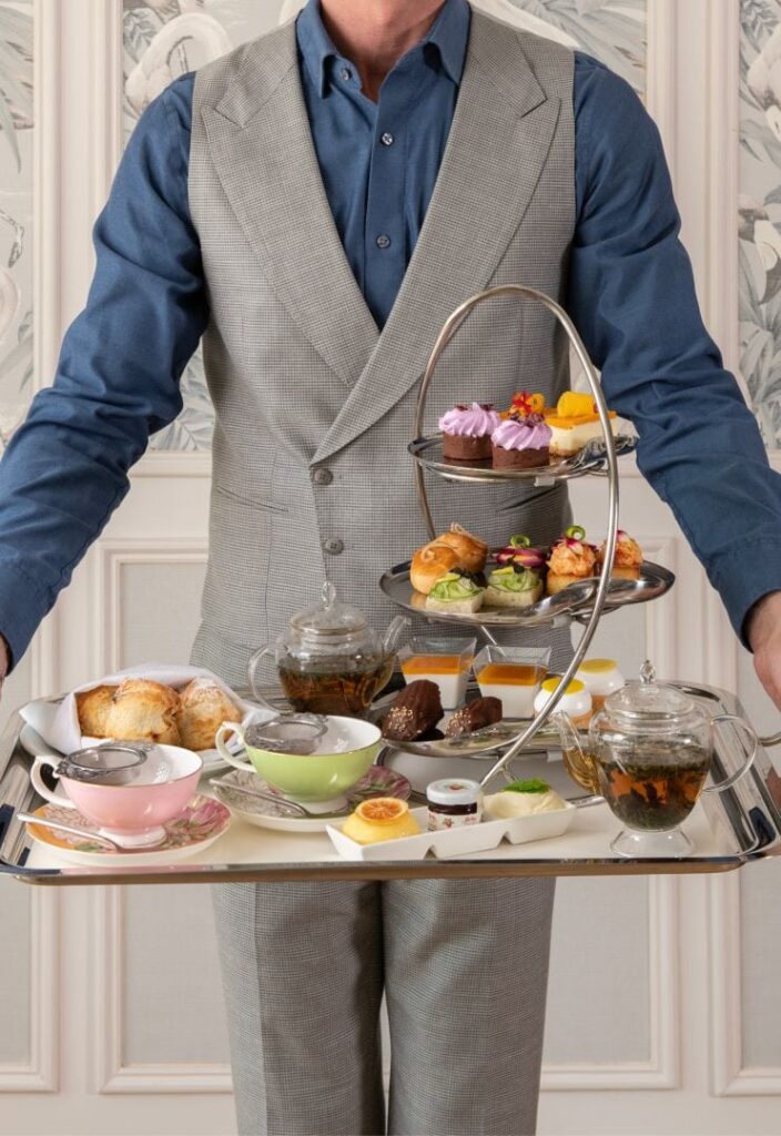 Luxury afternoon tea setup with assorted pastries, finger sandwiches, and fine teas at The London West Hollywood at Beverly Hills hotel.